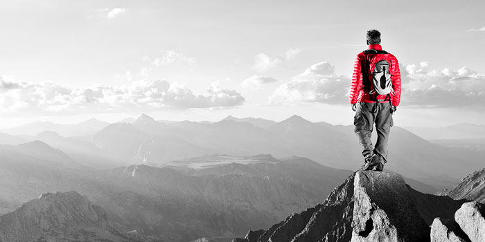 Man standing on a mountain | Atradius 